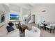 Spacious living room with a TV and stairs boasts an open layout, perfect for modern living and entertaining at 11832 E Clinton St, Scottsdale, AZ 85259