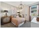 Charming bedroom featuring a warm color palette, decorative dresser, and unique lighting fixture at 1320 W Kennedy Ave, Coolidge, AZ 85128