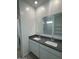 Bathroom with double vanity, granite countertop, and large mirror at 1360 W Hess Ave, Coolidge, AZ 85128
