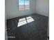 Minimalist bedroom with carpet, window, and neutral tones at 1360 W Hess Ave, Coolidge, AZ 85128