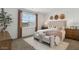 Well-lit bedroom features carpeted floors, a large window, and modern furnishings at 1360 W Hess Ave, Coolidge, AZ 85128
