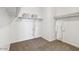 Walk-in closet features carpeted floors, built-in shelving, and clothing rods at 1360 W Hess Ave, Coolidge, AZ 85128