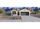 Inviting single-story home with desert landscaping and a two-car garage against a mountain backdrop at 1360 W Hess Ave, Coolidge, AZ 85128