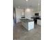 Charming kitchen with island, white cabinets, granite countertops, and stainless steel appliances at 1360 W Hess Ave, Coolidge, AZ 85128