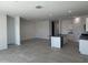 Bright open-concept living area with tile floors and a kitchen island at 1360 W Hess Ave, Coolidge, AZ 85128