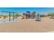 Community playground with swings, slides, climbing frame, and picnic pavilion on a sunny day at 1360 W Hess Ave, Coolidge, AZ 85128