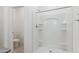 The white shower features built-in shelves, complemented by a nearby toilet and clean, modern design at 1408 W Hess Ave, Coolidge, AZ 85128