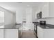 This kitchen offers stainless steel appliances, granite counters, white cabinets, and a functional island sink at 1408 W Hess Ave, Coolidge, AZ 85128