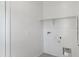 Bright laundry room with shelving and connections for washer and dryer, offering practicality and convenience at 1408 W Hess Ave, Coolidge, AZ 85128