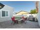 Backyard has a built-in fire pit surrounded by red chairs and a stainless steel grill at 2025 N 87Th Way, Scottsdale, AZ 85257