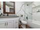 Modern bathroom featuring white marble wall, gray countertop, and framed mirror with a glass-enclosed tub and shower at 2025 N 87Th Way, Scottsdale, AZ 85257