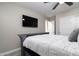 Comfortable bedroom featuring a ceiling fan, a television, and closet with sliding doors at 2025 N 87Th Way, Scottsdale, AZ 85257