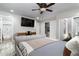 Bedroom featuring closet, TV, and ensuite bathroom at 2025 N 87Th Way, Scottsdale, AZ 85257