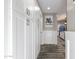 Hallway features ample white cabinetry, light gray walls with white trim and decorative art at 2025 N 87Th Way, Scottsdale, AZ 85257