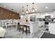 Spacious kitchen with a marble island, stainless steel appliances, and an adjacent dining area featuring wood accent wall at 2025 N 87Th Way, Scottsdale, AZ 85257