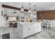 Open concept kitchen with marble island, stainless appliances, and seamless flow into the dining and living spaces at 2025 N 87Th Way, Scottsdale, AZ 85257