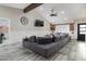 Open living room featuring vaulted ceilings with wood beam, large gray sectional sofa, and stylish decor at 2025 N 87Th Way, Scottsdale, AZ 85257