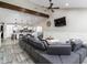 Open-concept living room featuring a modern gray sofa and views into the kitchen at 2025 N 87Th Way, Scottsdale, AZ 85257