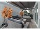 Cozy outdoor patio with wicker furniture, a glass table, and an artistic, orange tree at 2025 N 87Th Way, Scottsdale, AZ 85257