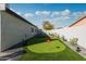 A custom putting green adds a touch of recreation to this well landscaped backyard at 2025 N 87Th Way, Scottsdale, AZ 85257
