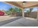 Covered back patio overlooks a well-landscaped yard with mature trees and bushes at 21192 E Stirrup St, Queen Creek, AZ 85142