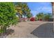 Landscaped backyard features mature trees, rock ground cover, and privacy wall at 21192 E Stirrup St, Queen Creek, AZ 85142