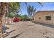 Spacious backyard with desert landscaping, mature trees, and partial perimeter wall at 21192 E Stirrup St, Queen Creek, AZ 85142