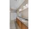 Bathroom featuring double sinks, a shower with white tile surround, and granite countertops at 21192 E Stirrup St, Queen Creek, AZ 85142