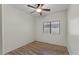 Simple bedroom with light hardwood floors, a ceiling fan, and a window allowing natural light at 21192 E Stirrup St, Queen Creek, AZ 85142