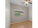Well-lit bedroom with hardwood flooring, ceiling fan and window with outside view at 21192 E Stirrup St, Queen Creek, AZ 85142