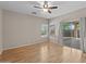 Spacious bedroom with hardwood flooring, ceiling fan, and glass sliding doors to patio at 21192 E Stirrup St, Queen Creek, AZ 85142