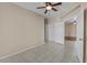 Neutral bedroom with a ceiling fan, tile floor, and closet with double doors at 21192 E Stirrup St, Queen Creek, AZ 85142