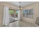 Dining room with large window, chandelier and sliding glass door to the backyard at 21192 E Stirrup St, Queen Creek, AZ 85142