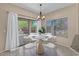 Cozy dining area featuring a modern chandelier and outdoor access, perfect for enjoying meals at 21192 E Stirrup St, Queen Creek, AZ 85142