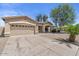 Spacious single-story home with a long driveway, desert landscaping, and a covered entryway at 21192 E Stirrup St, Queen Creek, AZ 85142
