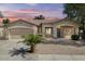 Charming single-story home with a two-car garage, desert landscaping, and a cozy front porch at 21192 E Stirrup St, Queen Creek, AZ 85142