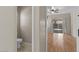 Hallway view of a powder room and a bedroom with hardwood floors and sliding glass doors to patio at 21192 E Stirrup St, Queen Creek, AZ 85142