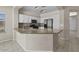 Bright kitchen features white cabinets, granite countertops, stainless steel appliances and decorative backsplash at 21192 E Stirrup St, Queen Creek, AZ 85142