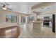 Open-concept living area showcases bright kitchen, hardwood floors and sliding doors to the back patio at 21192 E Stirrup St, Queen Creek, AZ 85142