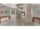 Open-concept living room with tile flooring, island, and access to the backyard through sliding glass doors at 21192 E Stirrup St, Queen Creek, AZ 85142