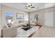 Bright living room features tile flooring, plush seating, ceiling fan, and lots of natural light at 21192 E Stirrup St, Queen Creek, AZ 85142