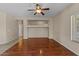 The living room features hardwood floors, a ceiling fan, and neutral paint at 21192 E Stirrup St, Queen Creek, AZ 85142