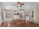 Open living area with hardwood floors, a ceiling fan, and views of the kitchen at 21192 E Stirrup St, Queen Creek, AZ 85142