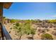 Balcony overlooking desert landscape and neighboring homes on a bright, sunny day at 2425 W Bronco Butte Trl # 2028, Phoenix, AZ 85085