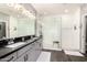 Modern bathroom featuring a double sink vanity, large walk-in shower with white subway tile, and dark wood-look flooring at 2425 W Bronco Butte Trl # 2028, Phoenix, AZ 85085