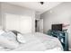 Bedroom featuring neutral paint with a large window, upholstered headboard, ceiling fan, and light blue media console at 2425 W Bronco Butte Trl # 2028, Phoenix, AZ 85085