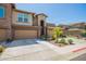 Charming home exterior with a two-car garage, desert landscaping, and decorative stone accents at 2425 W Bronco Butte Trl # 2028, Phoenix, AZ 85085