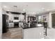 A fully remodeled gray and black kitchen with an oversized island and bar seating at 2425 W Bronco Butte Trl # 2028, Phoenix, AZ 85085