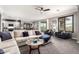 Spacious living room with neutral tones, views to the kitchen, a bar, and an outdoor patio at 2425 W Bronco Butte Trl # 2028, Phoenix, AZ 85085
