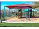 Community playground with slides, swings, and green grass perfect for families on a sunny day at 2425 W Bronco Butte Trl # 2028, Phoenix, AZ 85085